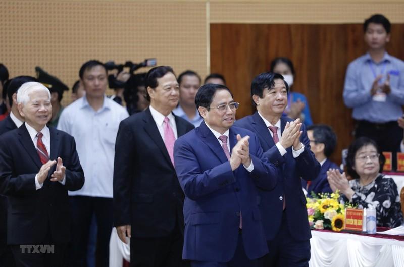 El primer ministro, Pham Minh Chinh, y los dirigentes y exlíderes del Partido y el Estado de Vietnam realizan el saludo a la bandera nacional.