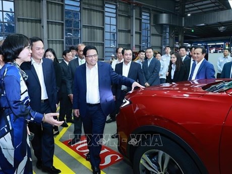 El primer ministro de Vietnam, Pham Minh Chinh, aprecia los modelos de carros fabricados en el país de Ford (Foto: VNA)