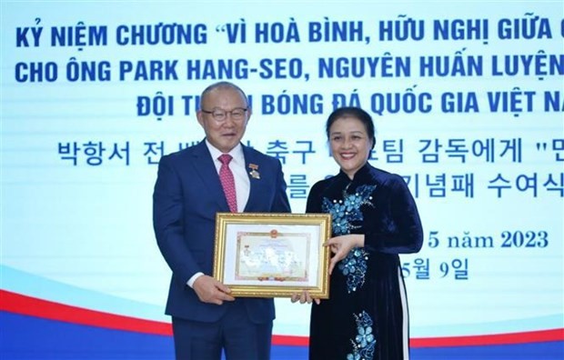La presidenta de la Unión de Organizaciones de Amistad de Vietnam, Nguyen Phuong Nga, entrega la distinción a Park Hang-seo, exentrenador de la selección nacional de fútbol. (Fotografía: VNA)