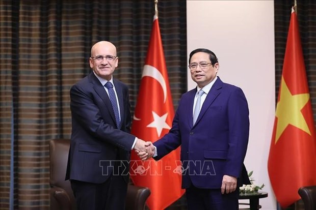 El primer ministro de Vietnam, Pham Minh Chinh (derecha), saluda al ministro turco de Hacienda y Finanzas, Mehmet Simsek. (Fotografía: VNA)