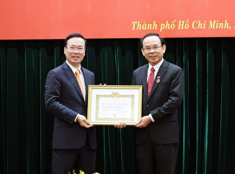 El presidente vietnamita, Vo Van Thuong, entrega la insignia por los 45 años de membresía en el Partido Comunista de Vietnam a Nguyen Van Nen, secretario del Comité partidista de Ciudad Ho Chi Minh. (Fotografía: VNA)
