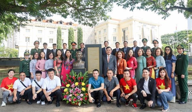 La comunidad vietnamita en Singapur deposita una ofrenda floral en la estatua del Presidente Ho Chi Minh. (Fotografía: VNA)