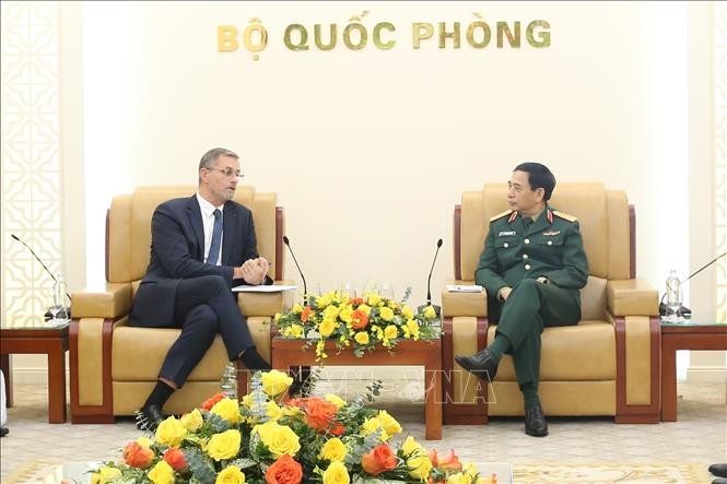 El ministro de Defensa, general Phan Van Giang, conversa con el embajador de Francia en Vietnam, Olivier Brochet. (Fotografía: VNA)