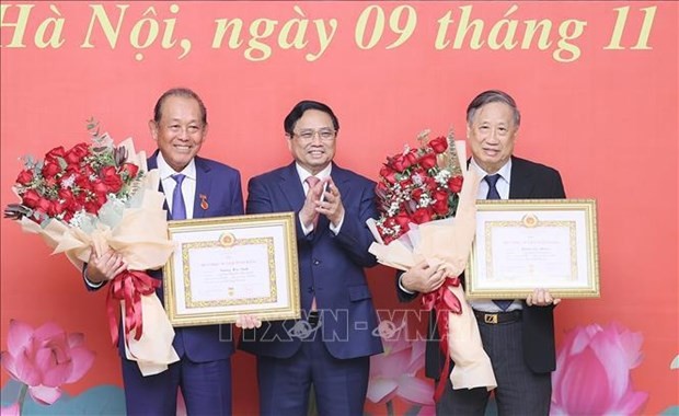 El primer ministro vietnamita, Pham Minh Chinh (centro), felicita a los ex viceprimeros ministros Truong Hoa Binh (primero, izquierda) y Pham Gia Khiem. (Foto: VNA)