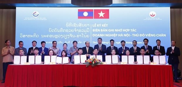 Durante la firma de memorandos de entendimiento de cooperación entre empresas de Hanói y Vientián (Foto: VNA)