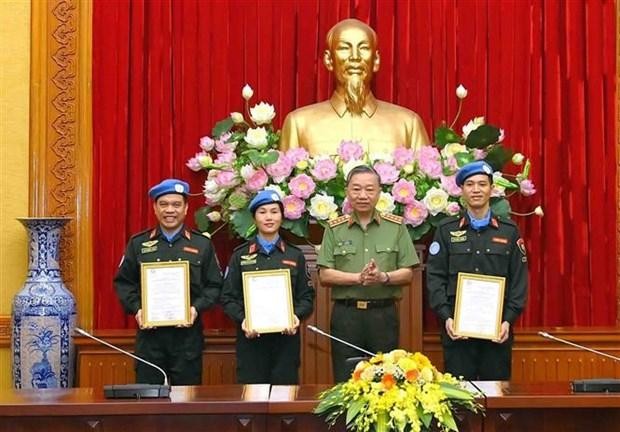 El ministro de Seguridad Pública, general To Lam, entrega la decisión del Presidente de Vietnam a los oficiales. (Fotografía: VNA)