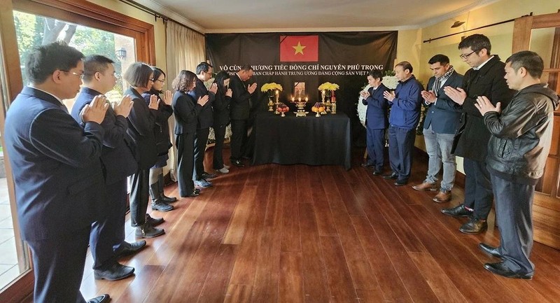 En un ambiente solemne, el embajador Pham Truong Giang y el personal de la Embajada y la Oficina Comercial de Hanói en Santiago de Chile, junto con sus familiares y representantes de la comunidad vietnamita en el país latinoamericano, guardan un minuto de silencio para rendir tributo al líder partidista.