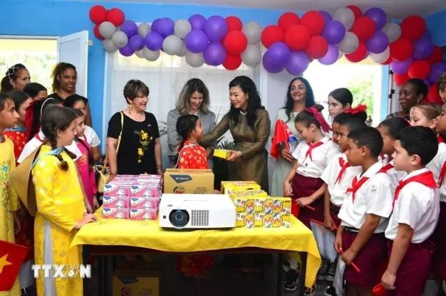 Ngo Phuong Ly, esposa del secretario general del Partido Comunista y presidente de Vietnam, con los alumnos de la escuela primaria Vo Thi Thang. (Foto: VNA)