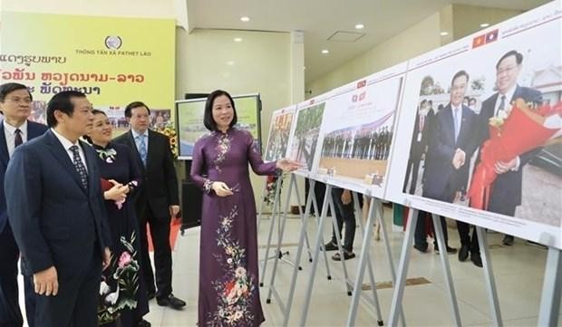 La directora general de VNA, Vu Viet Trang, presenta fotos a los delegados en la exposición. (Fotografía: VNA)