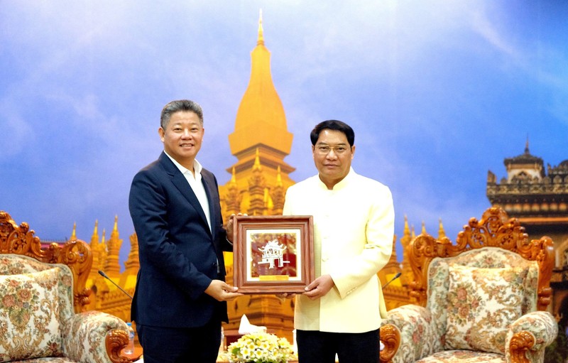 El vicepresidente del Comité Popular de Hanói, Nguyen Manh Quyen (Derecha), entrega un regalo al miembro del Comité Central del Partido Popular Revolucionario de Laos, subsecretario del Comité partidista y alcalde de Vientián, Atsaphanthong Siphandone. (Foto: hanoimoi.vn)