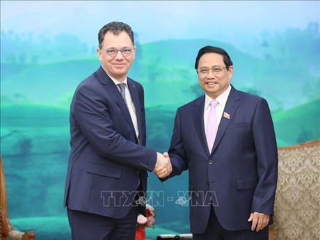 El primer ministro de Vietnam, Pham Minh Chinh (derecha), recibe al ministro rumano de Economía, Emprendimiento y Turismo, Stefan-Radu Oprea. (Foto: VNA)