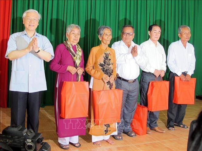 El secretario general Nguyen Phu Trong entregó obsequios a las familias beneficiadas de políticas preferenciales en la nueva comuna rural de Ngoc To, el distrito de My Xuyen, durante su visita a Soc Trang, el 9 de marzo de 2015. (Foto: VNA)