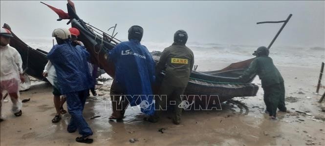 Las la provincia de Thua Thien-Hue ayudan a los pescadores a trasladar sus embarcaciones a la costa antes de que la tormenta Trami llegue a tierra firme. (Fuente: VNA)