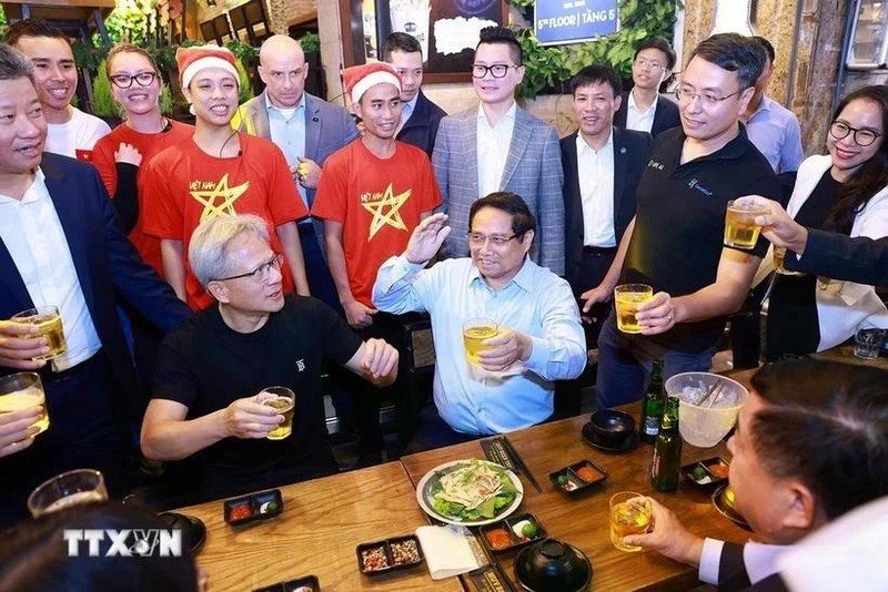 El primer ministro de Vietnam, Pham Minh Chinh, y el director ejecutivo de NVIDIA, Jensen Huang, disfrutan de la comida callejera de Hanói el 5 de diciembre de 2024. (Foto: VNA)