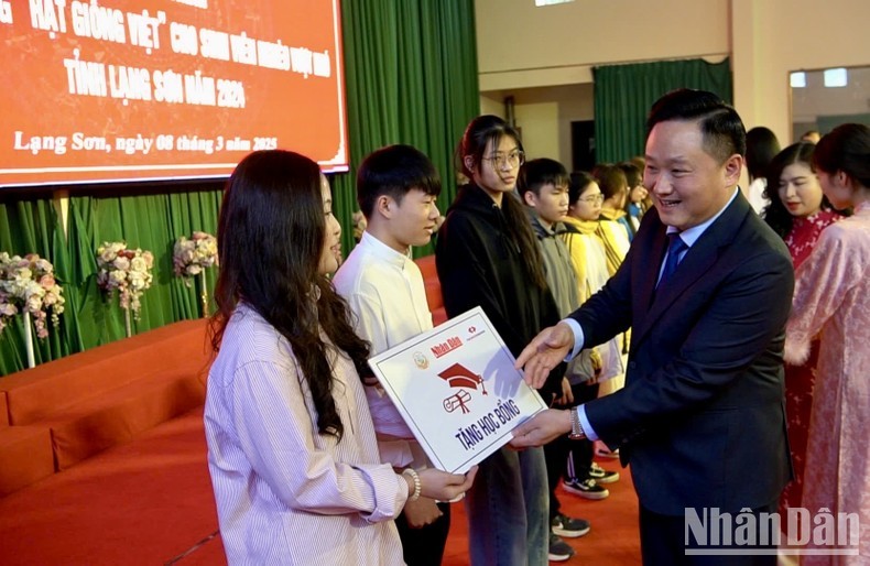 Phan Van Hung, subjefe de redacción del periódico Nhan Dan y presidente del Fondo de Semillas de Vietnam, entrega becas a los estudiantes.