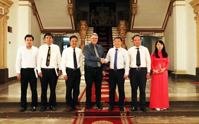 Duong Anh Duc y Troels Jakobsen, junto con otros asistentes al encuentro. (Fotografía: VNA)