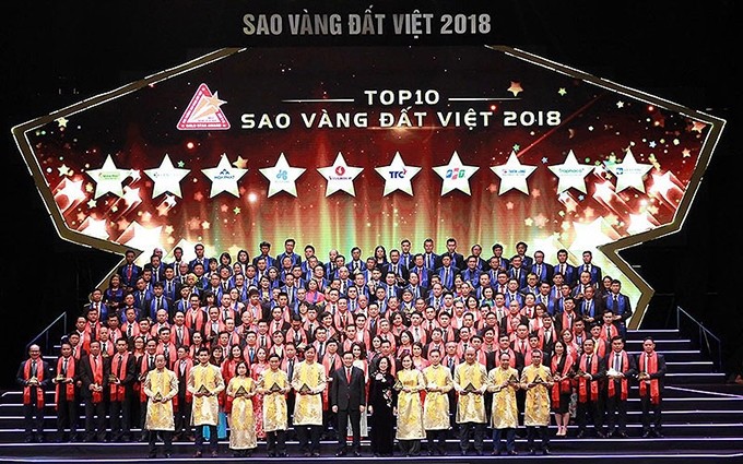 Dirigentes del Partido y del Estado junto con empresarios que ganaron el Premio Estrella Dorada de Vietnam 2018.