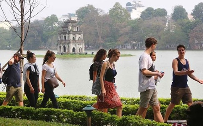 Turistas extranjeros visitan el lago Hoan Kiem, Hanói. (Fotografía: VNA)