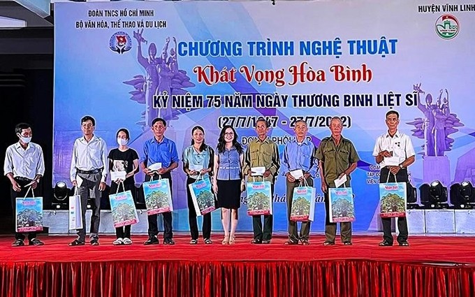 La secretaria del Comité de la Unión en Nhan Dan, Le Khanh Binh, otorga regalos a representantes de las familias necesitadas en Vinh Linh. (Fotografía: Nhan Dan)